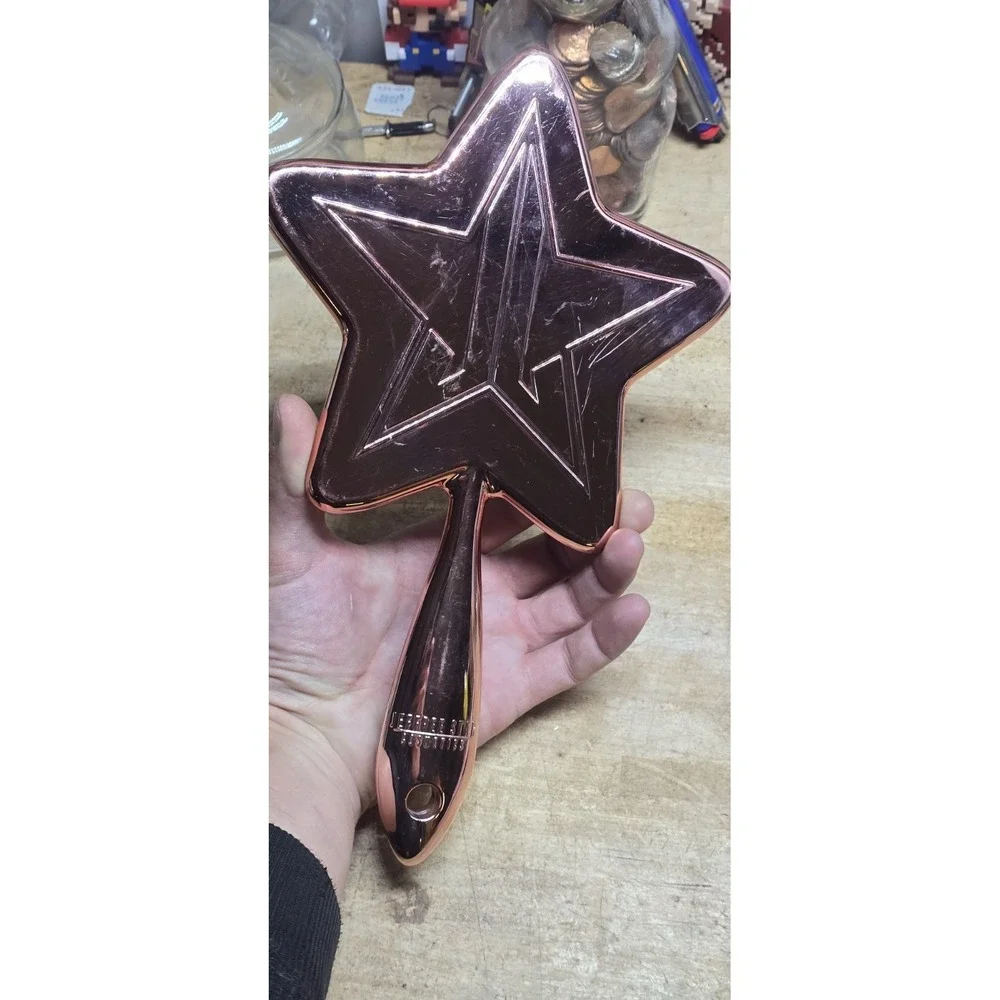 Jeffree Star Cosmetics Rose Gold Chrome Star Hand Mirror.